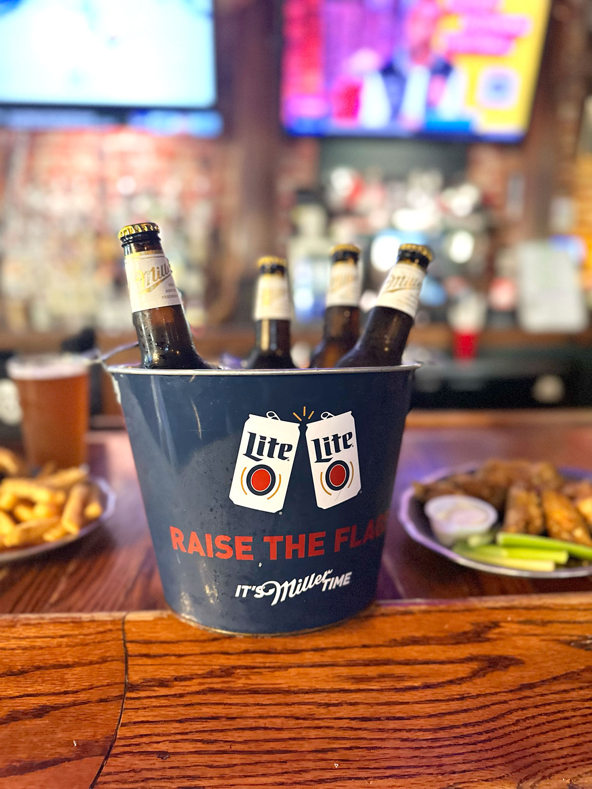A bucket of cold bottles on the bar