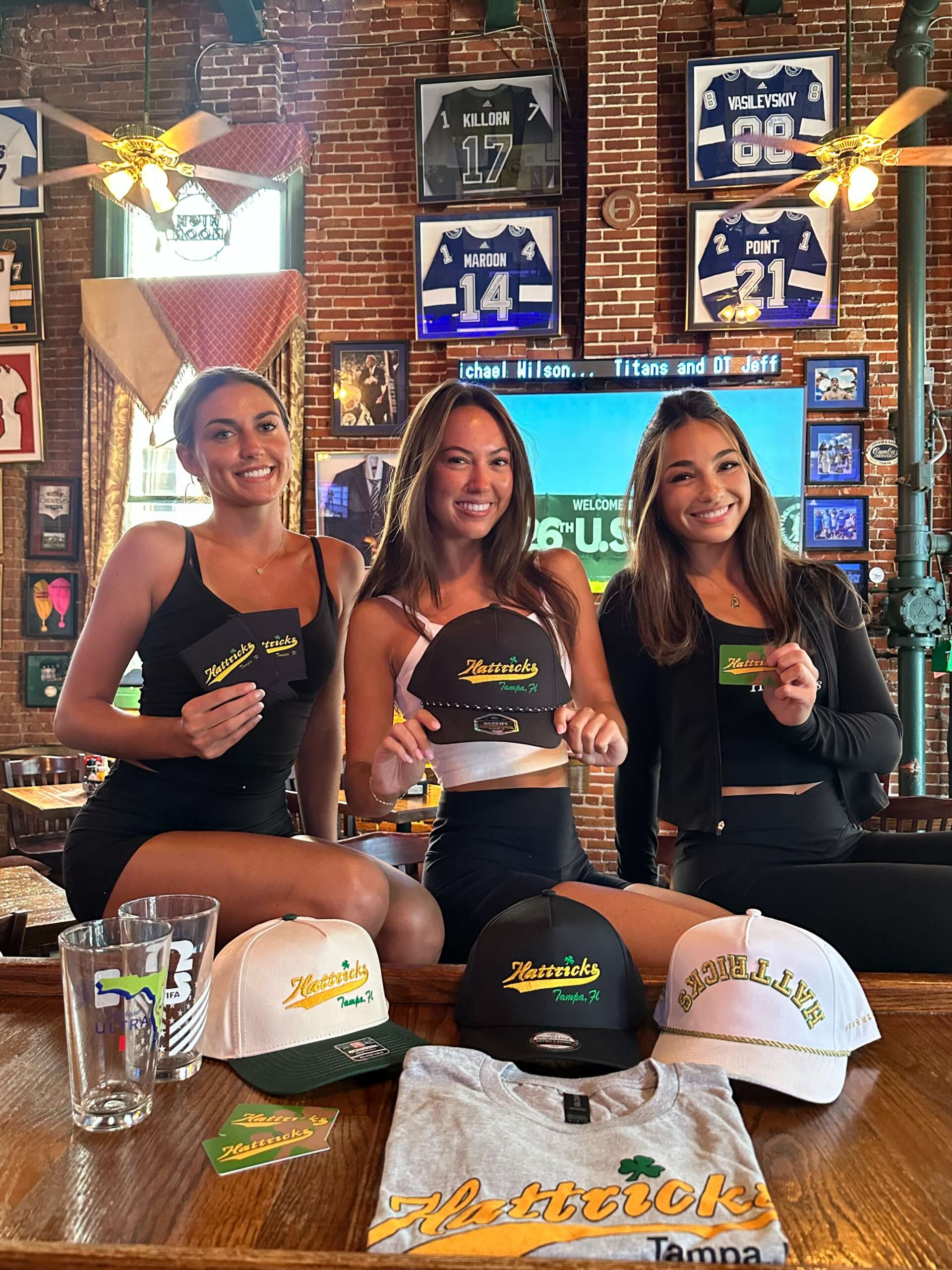 Hattricks tanks, hats, tee, koozies and a pint glass in the bar